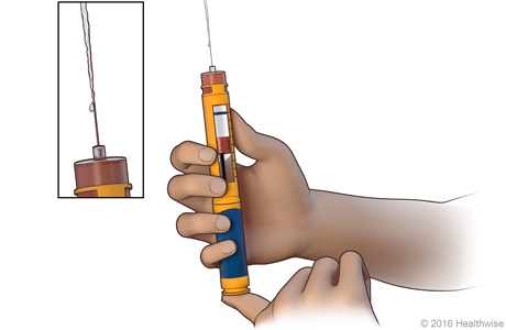 Priming the needle, with close-up of insulin coming out of the needle